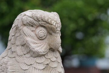 Detailed Stone Owl Sculpture with Intricate Feather Patterns and Natural Background