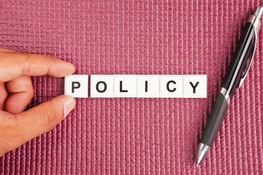 Pen with the word policy. basic concepts or organizational policies. a deliberate system of guidelines to guide decisions and achieve rational outcomes.