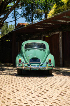 Green Volkswagen Beetle rear view, Classic vintage German car parked outdoors