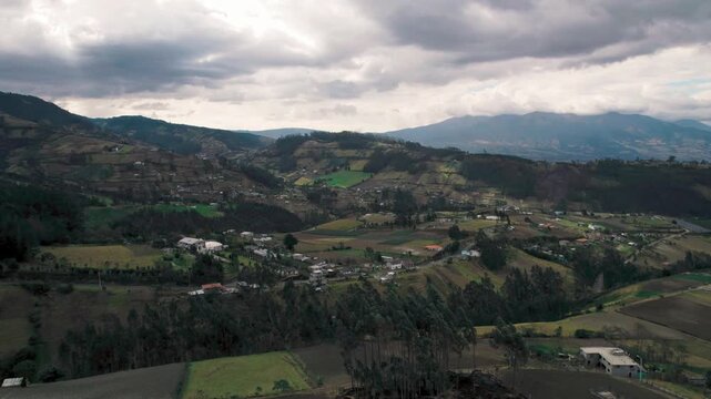 The Otavalo city and valley, showcasing the famous indigenous market, colorful town, and the majestic Imbabura volcano and San Pablo Lake in the Ecuadorian Andes.