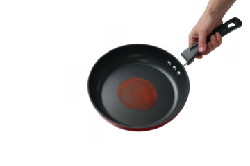 Hand holding frying pan with red substance isolated on a transparent background