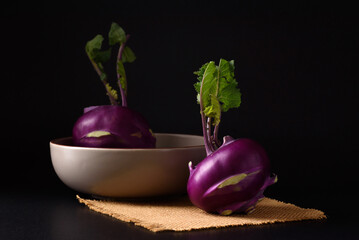 Ripe purple kohlrabi, freshly harvested from an organic farm, placed on a black background, is a healthy ingredient for cooking