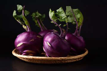 Ripe purple kohlrabi, freshly harvested from an organic farm, placed on a black background, is a healthy ingredient for cooking