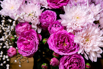 Colorful bouquet with various flowers displayed, showcasing roses, chrysanthemums, and baby’s breath in a close setting, created for a special occasion