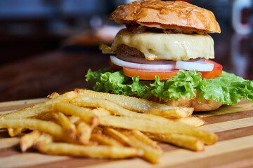 Gourmet Burgers With French Fries on a Wooden Table