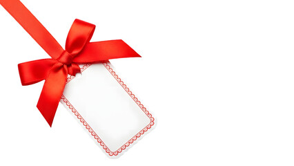 Red ribbon bow and blank white gift tag on a black background