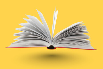 Open book with blank pages on a bright yellow background