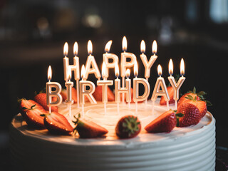 Birthday Cake With Lit Candles And Strawberries Dark Background