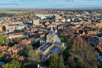 Fototapeta premium Aerial drone photography of the centre of Aylesbury town in Buckinghamshire, England. Featuring a church which is perched on top of a hill in the town centre and overlooks the surrounding Chilterns