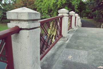 Old stone bridge with railing pathway in a public park