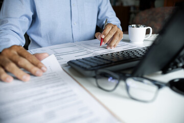 close up shot, asian businessman using digital tablet working and meeting online with documents checking business contract to making business plan
