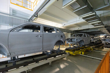 Car bodies are on assembly line. Modern automotive industry. Automobile conveyor