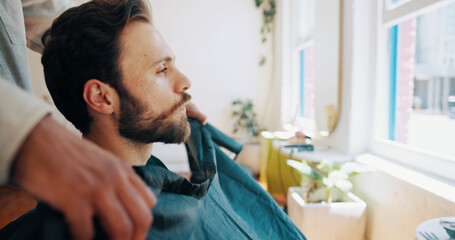 Man, barber and profile with preparation for haircut, styling or grooming in barbershop. Male person, hairdresser or getting ready with stylist with cape, trim or cut hairstyle in beauty parlor