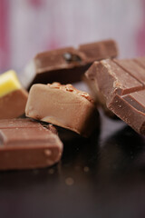 Chocolate pieces are scattered on a flat surface