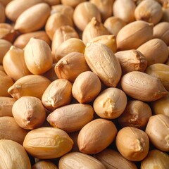 Close-up of numerous shelled peanuts, warm lighting on food