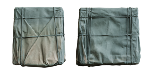 A stack of old brown paper books and fashion leather bags with blue cotton jeans is isolated on a white background as a textile object