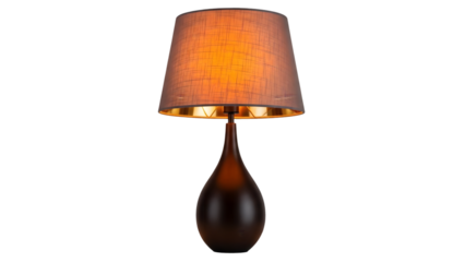 Elegant table lamp with warm orange light on black background