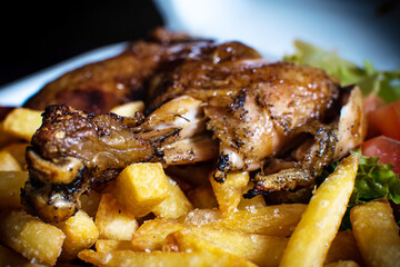 Delicious BBQ chicken served with crispy French fries and fresh salad. Tasty grilled meal with smoky flavor, perfect for food photography, restaurant menus, ads, and culinary promotions.