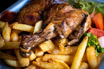 Delicious BBQ chicken served with crispy French fries and fresh salad. Tasty grilled meal with smoky flavor, perfect for food photography, restaurant menus, ads, and culinary promotions.
