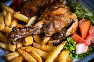 Delicious BBQ chicken served with crispy French fries and fresh salad. Tasty grilled meal with smoky flavor, perfect for food photography, restaurant menus, ads, and culinary promotions.