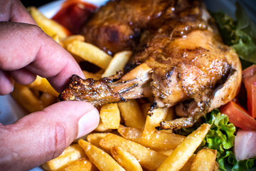Delicious BBQ chicken served with crispy French fries and fresh salad. Tasty grilled meal with smoky flavor, perfect for food photography, restaurant menus, ads, and culinary promotions.