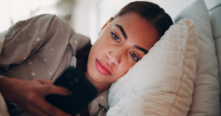Woman, phone and texting in bed, home and scroll with chat, check notification or post on web. Person, smartphone and tired with click on mobile app, pyjamas or contact on social network at apartment