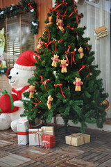 A Cute Teddy Bear Christmas Tree with Festive Gifts and a Giant Santa Bear.