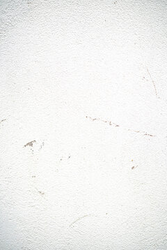 Textured white wall with subtle imperfections and scratches.