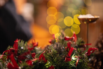 Festive holiday wreath with green foliage and red ribbons, creating a warm, cozy atmosphere.