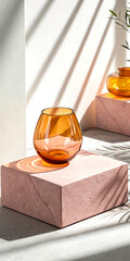 Transparent amber glass on pink platform