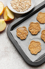 Homemade apple oat dog treats baking on parchment paper