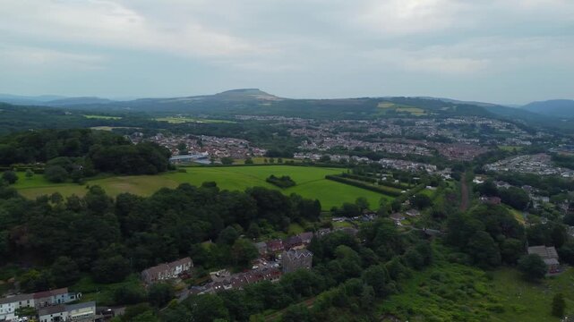 Panoramic drone fly over Neath Abbey district with suburbs area of Neath town and beautiful green hills, Wales, United Kingdom, UK
