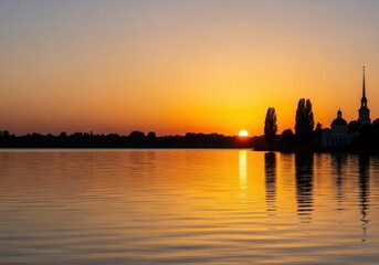 Fototapeta premium A beautiful tranquil evening landscape view showing the magnificent sunset with silhouettes of trees and structures against the vibrant golden sky, silhouette, serene, nightfall