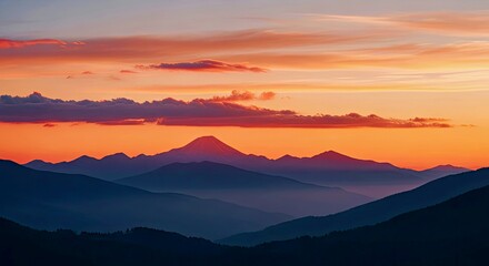 Dramatic Mountain Range Silhouette at Sunset With Orange Sky and Clouds.jpg