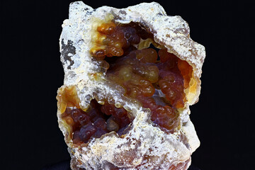 Striking kidney-shaped chalcedony specimen featuring botryoidal formations, a rough white exterior, dark background isolation. Prioksky or Golutvin quarry, Moscow region, Russia