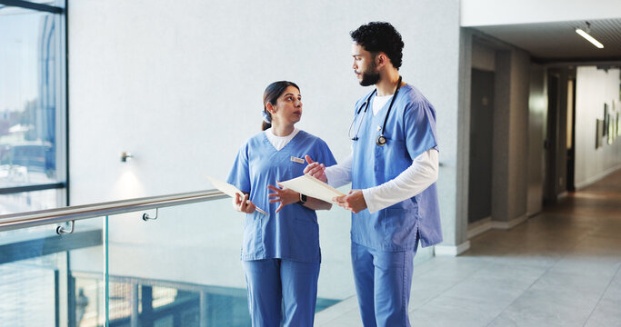 Nurse, talking and people in hospital, documents and healthcare with feedback. Medical service, man and woman in clinic, paperwork and report for diagnosis, discussion and advice with research - Powered by Adobe