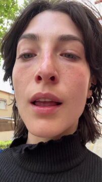 UGC POV video walking through the city while recording herself with her mobile phone