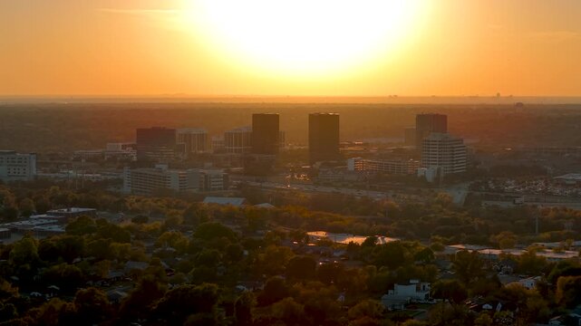Aerial view of Richardson, Texas cityscape during golden evening sunlight.