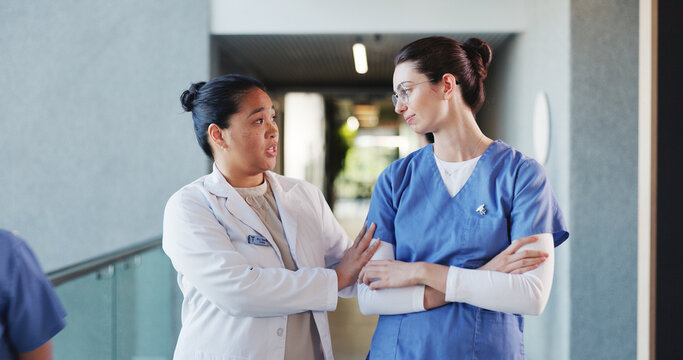 People, doctors and talking with sadness in hospital for staff shortage, treatment delay and mistake. Women, nurse and discussion of medical issues, healthcare malpractice and comfort for reassurance