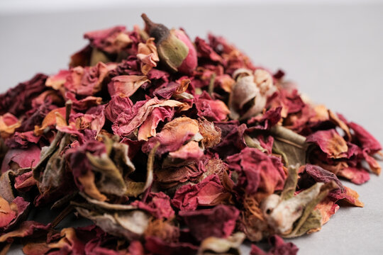 Extreme Close-up of Dried Pink and Red Rose Petals (Rosa damascena) with Unopened Bud for Culinary and Aromatic