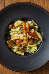 Crisp lettuce and vibrant tomatoes combine with juicy grilled chicken in a deep bowl