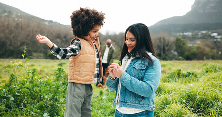 Happy, mom and child with plant, countryside and bonding on holiday, outdoor and together in nature. Family, adventure and people with boy on vacation, eco friendly and woman with smile for trip