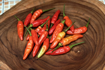Fresh Red Cayenne pepper on a wooden cutting board, Stack of vegetables. 