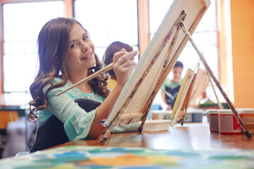 Portrait, girl and painting in class for art, creative talent and development in school. Education, student drawing and child with watercolor for learning, artwork and sketch on canvas with brush