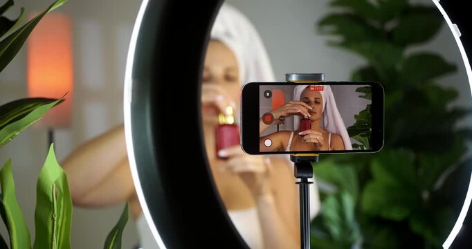 Influencer Applies Skincare at Home with Smartphone