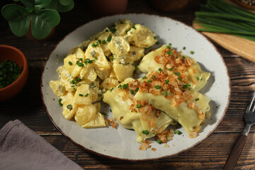 Traditional Swabian dish Maultaschen served with roasted onion and potato salad	