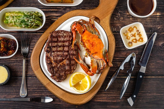 Tenderloin steak served with whole crab and lemon wedge
