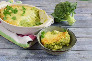 Baked broccoli with cheese on baking dish garnish with parsley