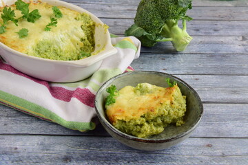Baked broccoli with cheese on baking dish garnish with parsley