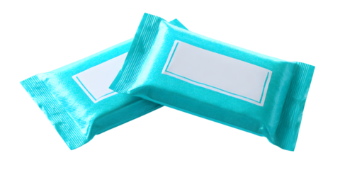 A close-up view of two teal-colored individual packets lying together on a black background isolated on white background